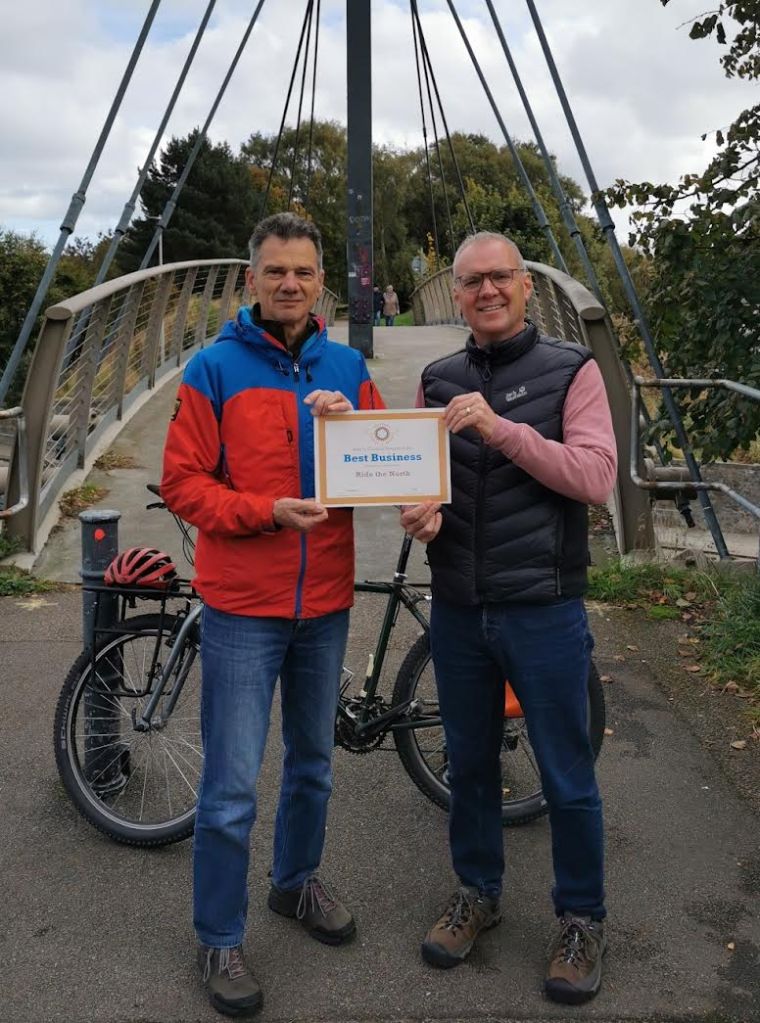 Ride the North receiving their award for best business.