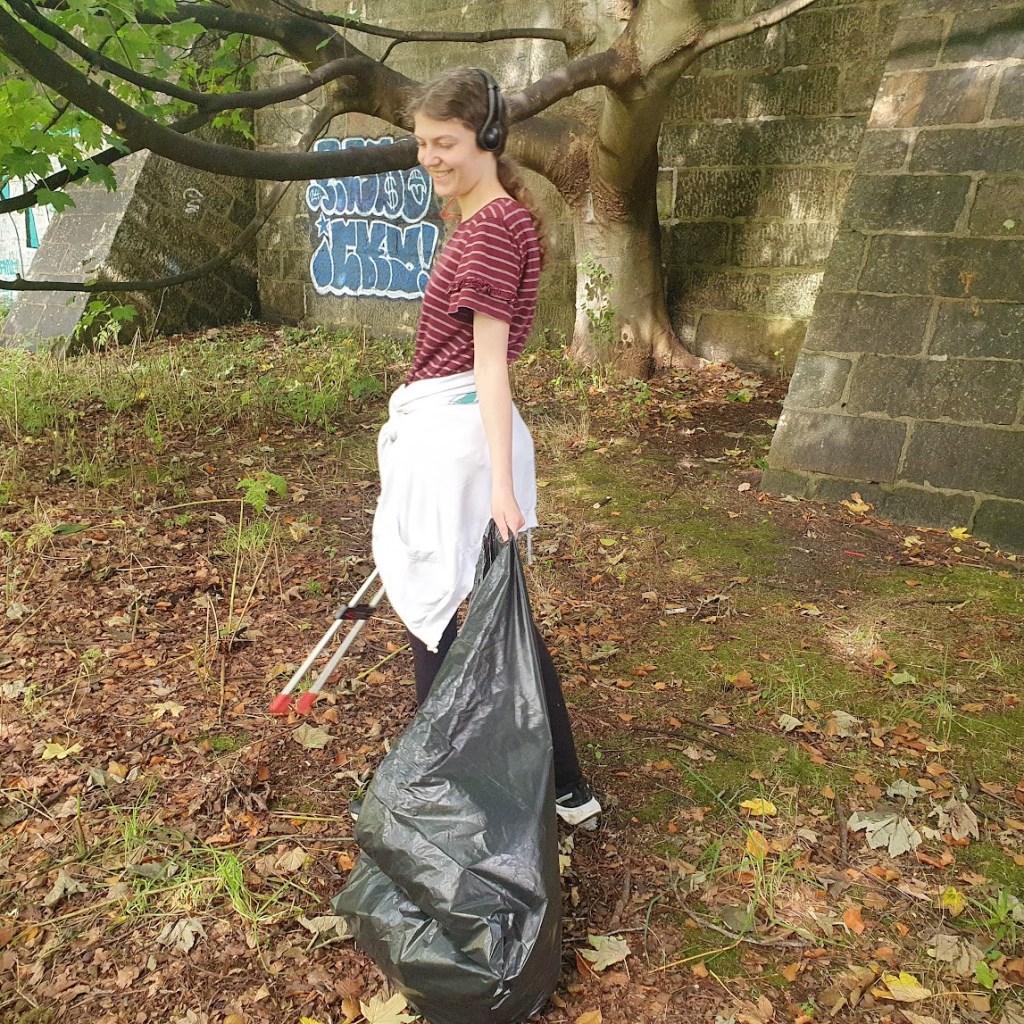 Elizabeth listening to music while collecting litter