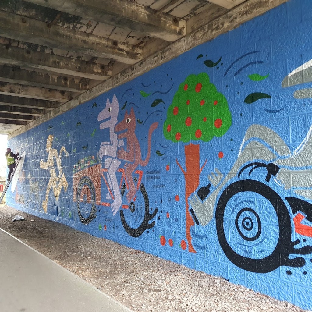 The middle of the mural with the cargo bike and an apple tree.