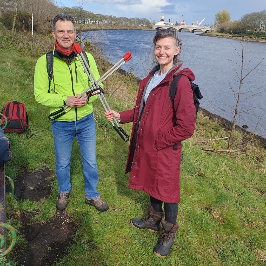 Me and Gavin holding out pickers with the River Dee in the background